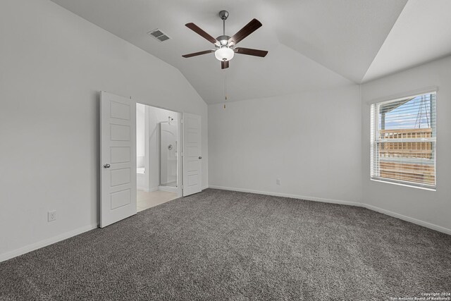 unfurnished bedroom with connected bathroom, vaulted ceiling, ceiling fan, and carpet