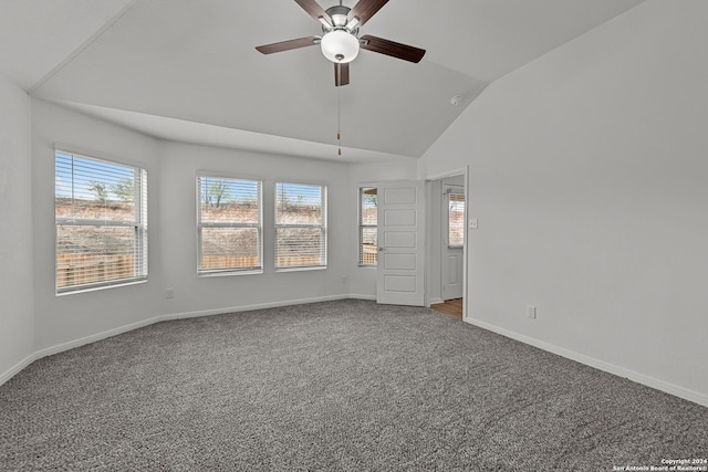 empty room featuring vaulted ceiling, carpet, and ceiling fan