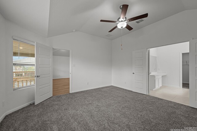 unfurnished bedroom with ceiling fan, lofted ceiling, and light carpet