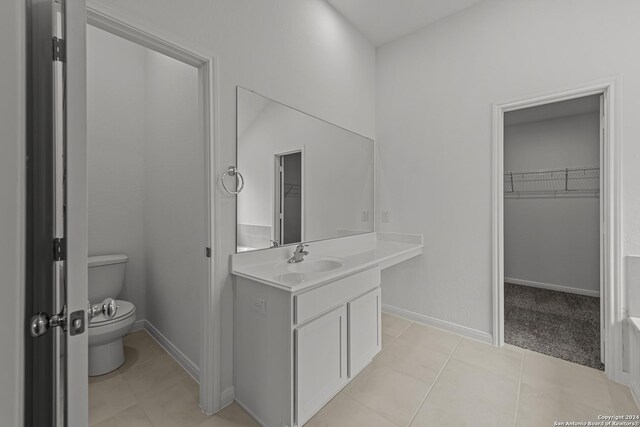 bathroom featuring tile patterned floors, vanity, and toilet