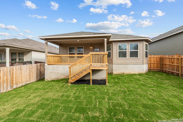 rear view of house featuring a yard