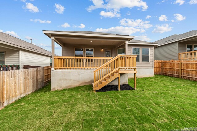 rear view of property featuring a lawn