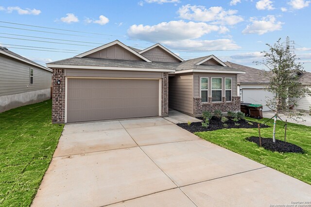 view of front of home featuring a garage and a front lawn