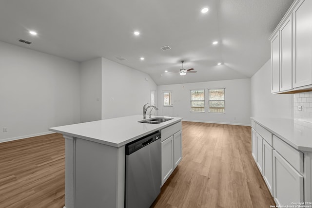 kitchen featuring an island with sink, sink, white cabinets, stainless steel dishwasher, and light wood-type flooring