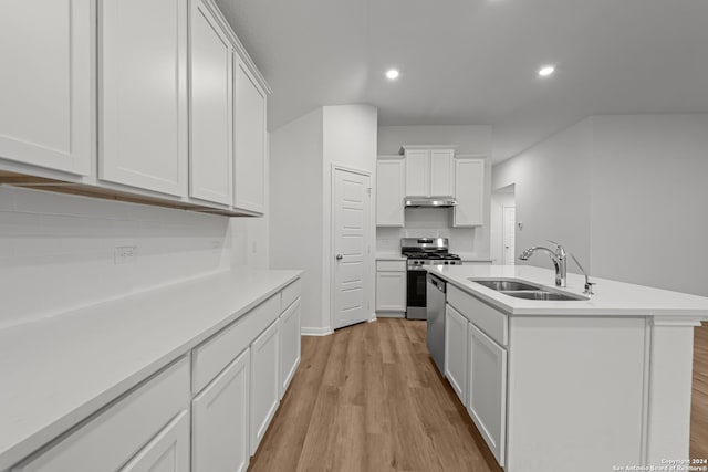 kitchen featuring sink, an island with sink, stainless steel appliances, light hardwood / wood-style floors, and white cabinets