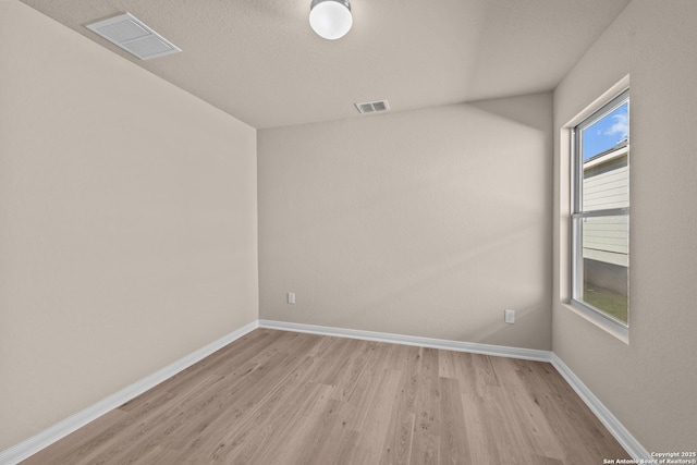 spare room featuring light hardwood / wood-style flooring