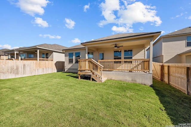 back of house featuring a lawn and ceiling fan