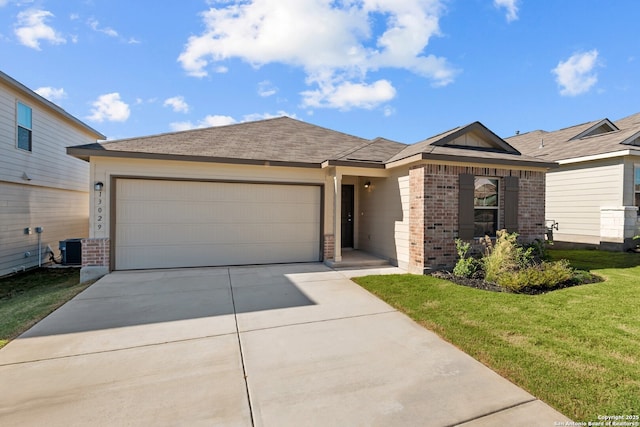 view of front of home with a garage, central AC unit, and a front yard