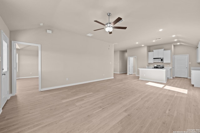 unfurnished living room featuring ceiling fan, light hardwood / wood-style flooring, and lofted ceiling