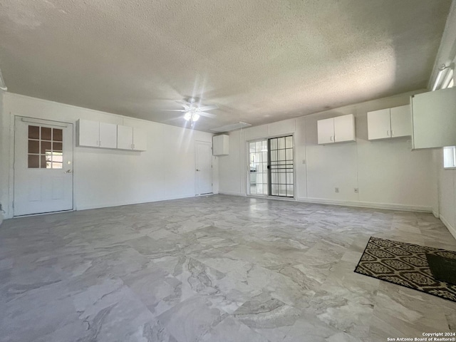 spare room featuring a textured ceiling and a wealth of natural light