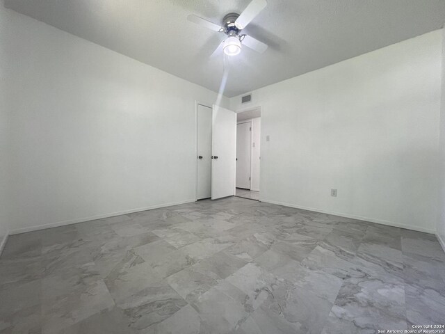 empty room featuring ceiling fan