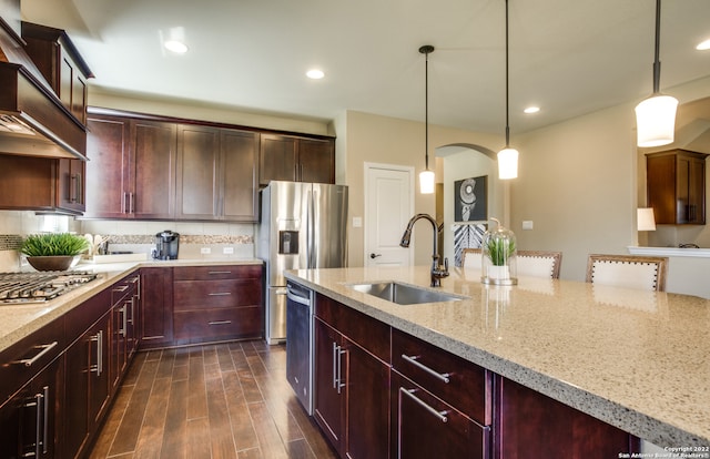 kitchen featuring sink, decorative light fixtures, dark hardwood / wood-style flooring, and custom range hood