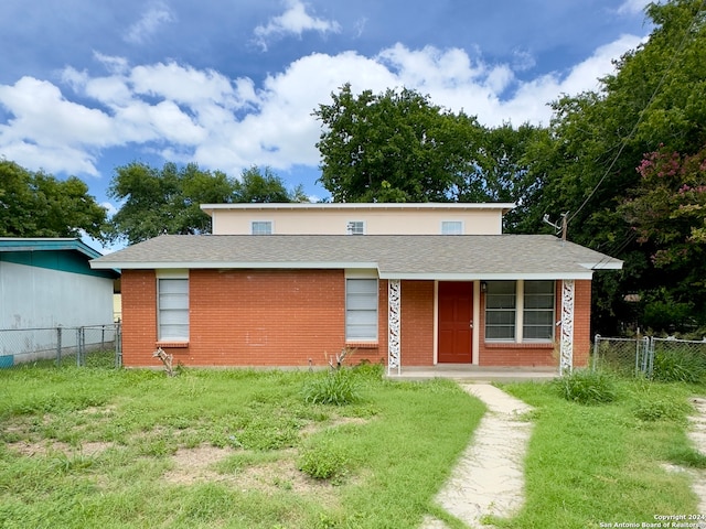 rear view of property with a lawn