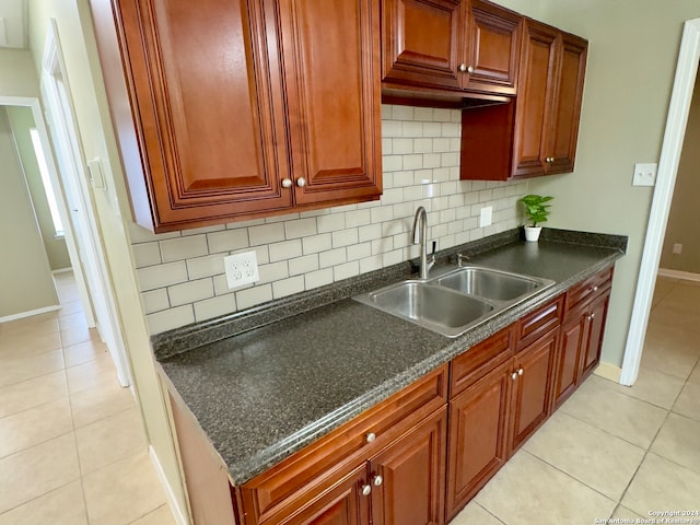 kitchen with sink, light tile patterned flooring, and tasteful backsplash