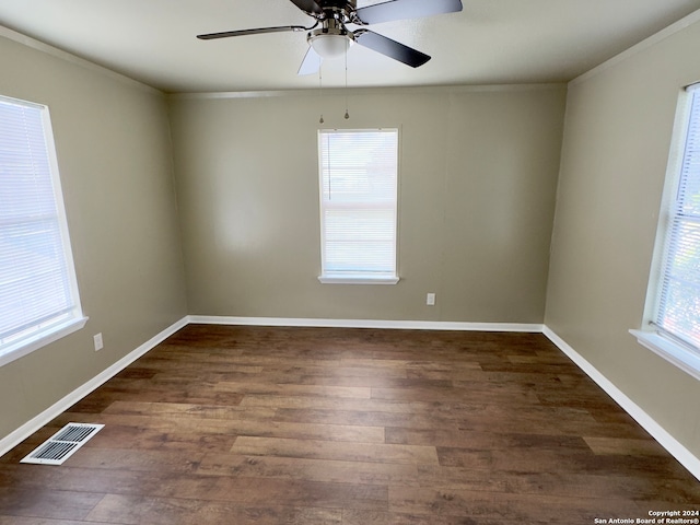 spare room with ornamental molding, dark hardwood / wood-style flooring, and ceiling fan