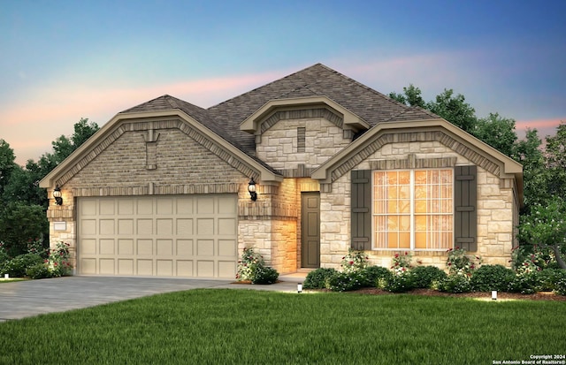 view of front of home with a lawn and a garage