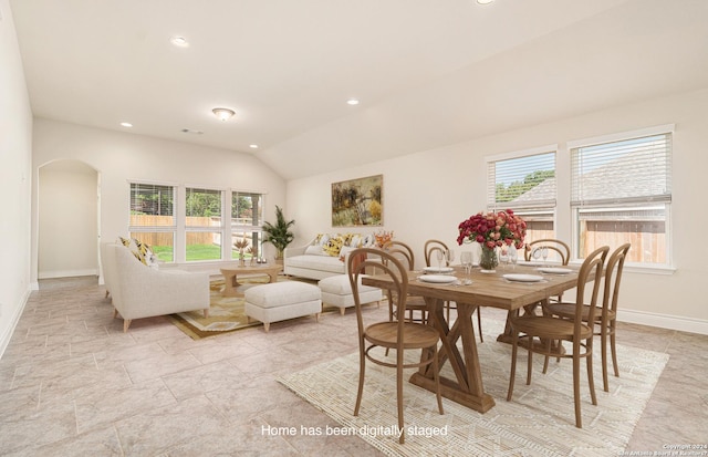 dining space with lofted ceiling