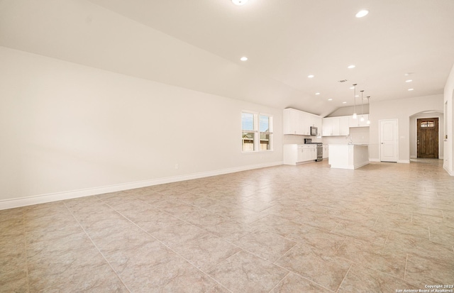 unfurnished living room with lofted ceiling