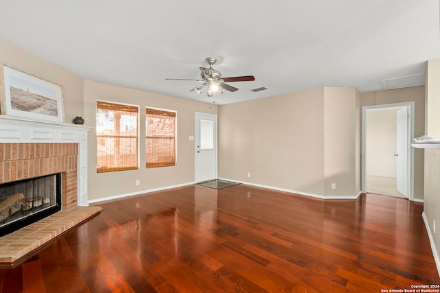 unfurnished living room featuring ceiling fan, dark hardwood / wood-style flooring, and a fireplace