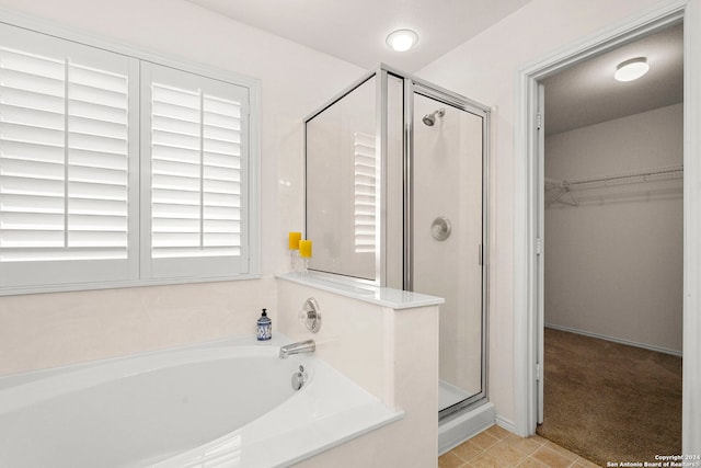 bathroom featuring shower with separate bathtub and tile patterned floors