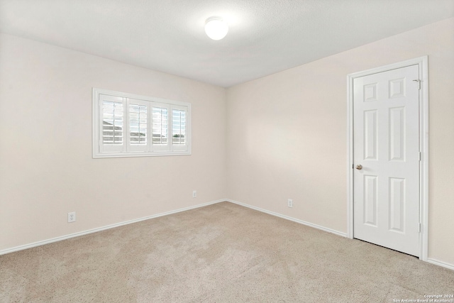 spare room with light carpet