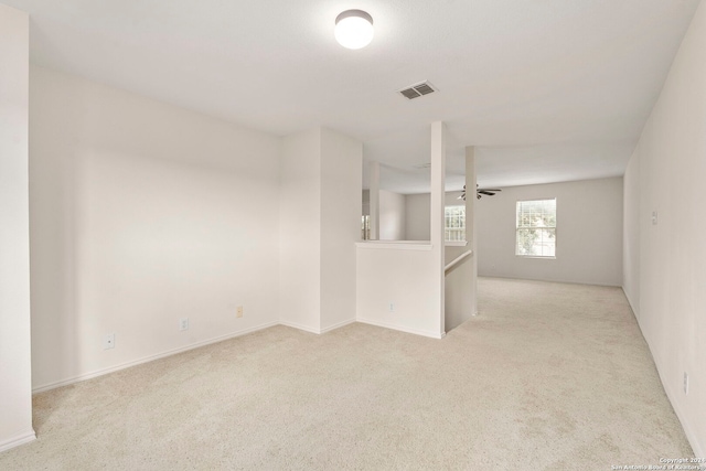 carpeted empty room featuring ceiling fan