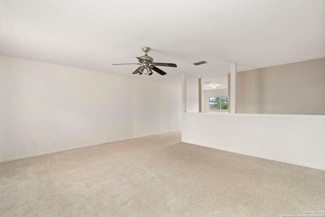 unfurnished room with light carpet and ceiling fan