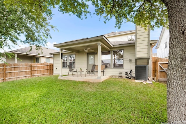 rear view of property featuring ceiling fan, cooling unit, a patio area, and a yard