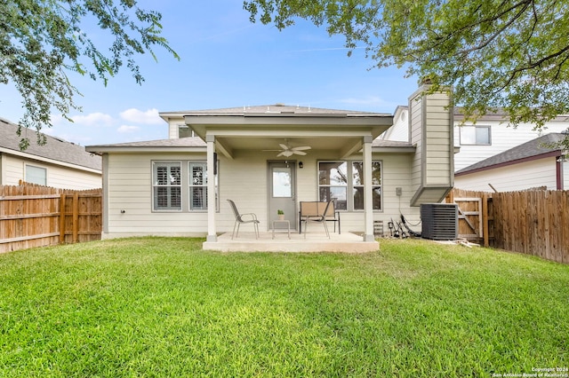 rear view of property featuring ceiling fan, central AC unit, a yard, and a patio