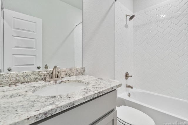 full bathroom with vanity, tiled shower / bath combo, and toilet