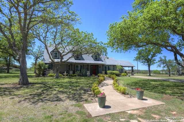 cape cod home with a front lawn