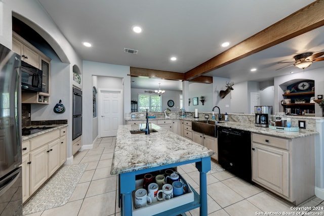 kitchen featuring ceiling fan with notable chandelier, black appliances, light stone countertops, and sink