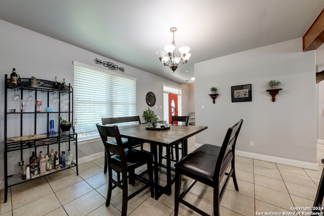 dining area featuring a chandelier and light tile patterned floors