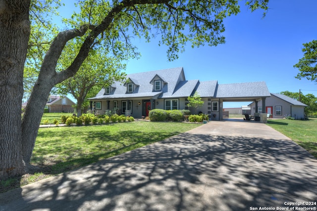 cape cod home with a carport and a front yard