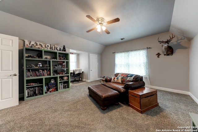 carpeted living room featuring ceiling fan and vaulted ceiling