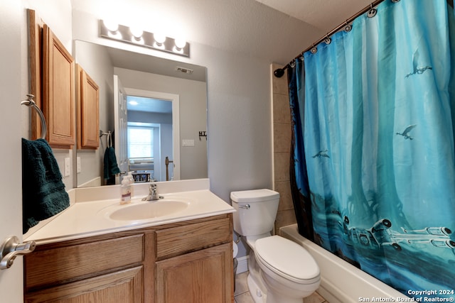 full bathroom with a textured ceiling, toilet, vanity, tile patterned floors, and shower / tub combo