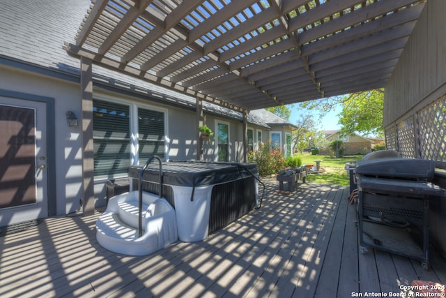 deck featuring a pergola and a hot tub