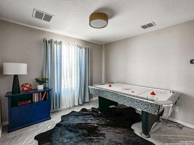 game room with a textured ceiling