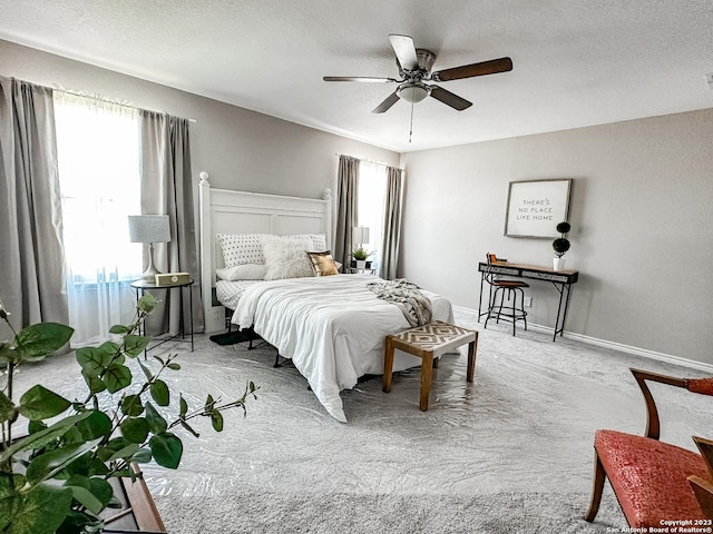 carpeted bedroom with ceiling fan and multiple windows