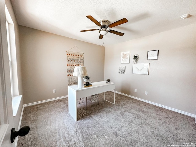 unfurnished office with ceiling fan, carpet, and a textured ceiling