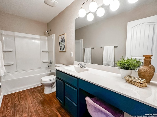 full bathroom with shower / washtub combination, toilet, hardwood / wood-style floors, and vanity