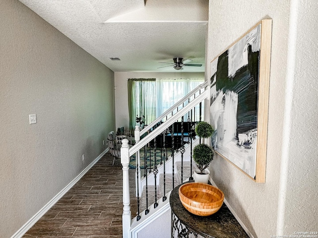 interior space with ceiling fan and a textured ceiling