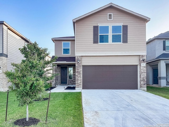 view of front of home featuring a garage and a front lawn