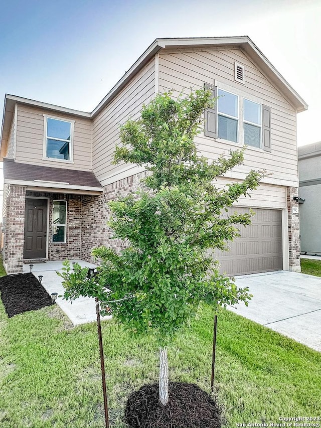 view of front of home featuring a garage and a front lawn