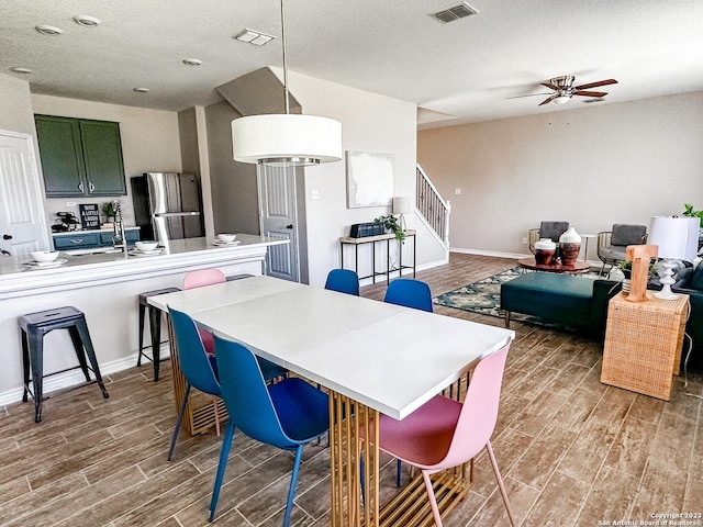 dining room featuring sink and ceiling fan