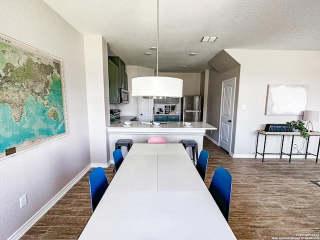 dining space with a textured ceiling