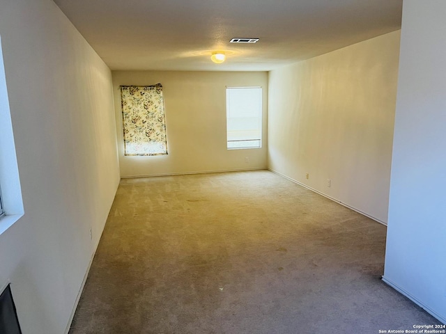 empty room featuring carpet flooring and visible vents