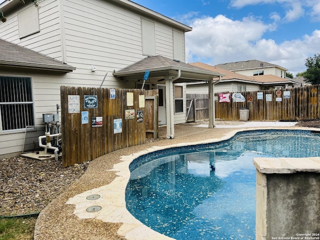 view of swimming pool featuring fence and a fenced in pool