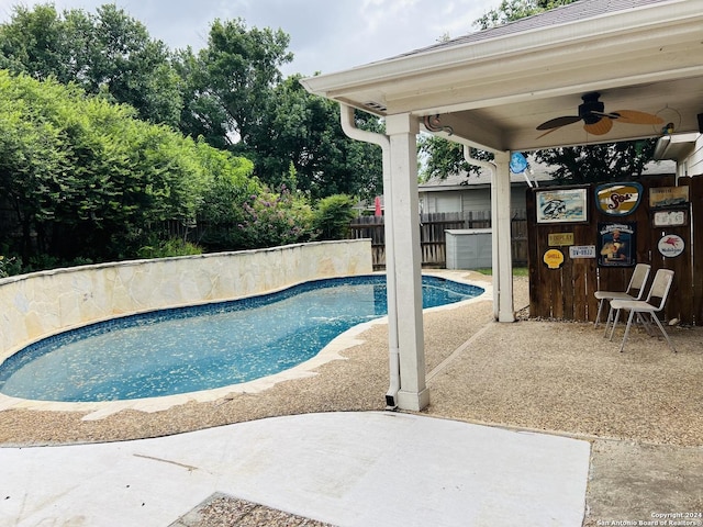 view of pool with a fenced in pool, a patio area, fence, and ceiling fan