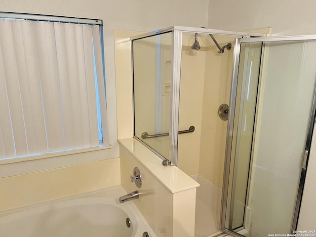 full bathroom with a stall shower and a garden tub